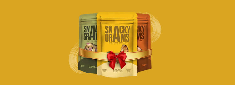 Three snack packages with a red bow on a yellow background, featuring the brand 'Snacky Grams'.