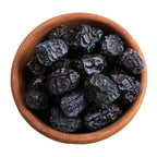 Wooden bowl filled with ajwa dates