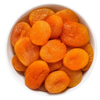 White bowl filled with dried apricots
