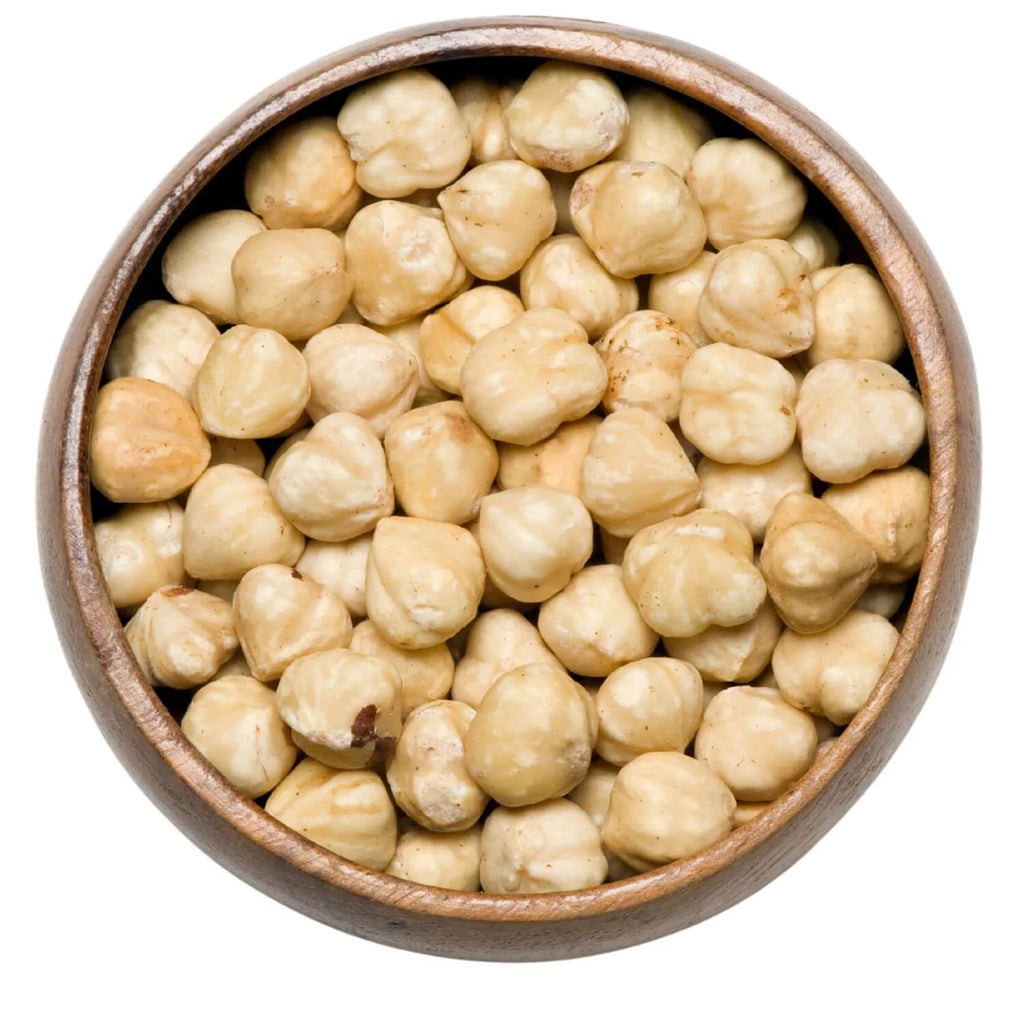 Wooden bowl filled with blanched  hazelnuts