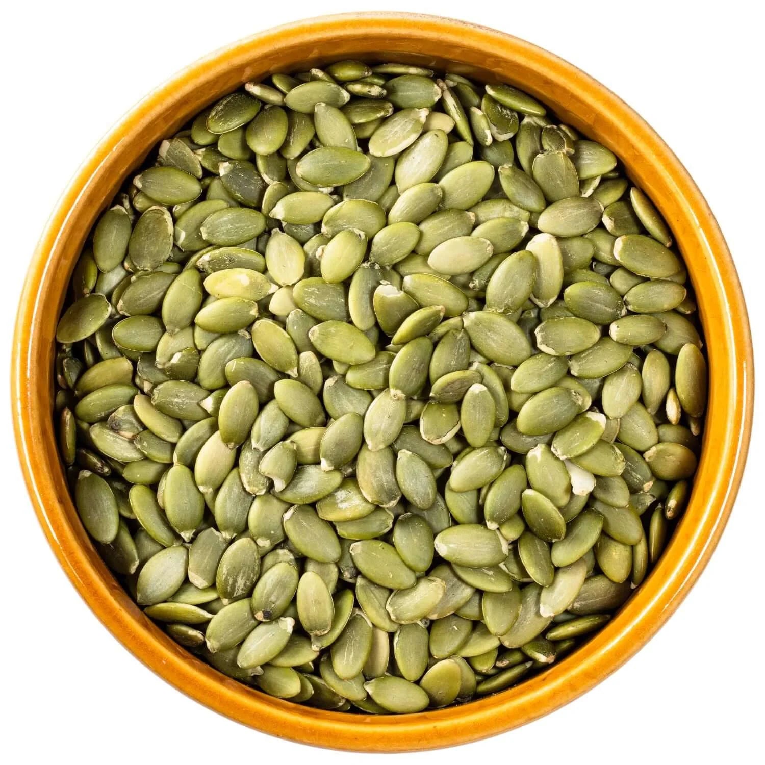 Bowl of green pumpkin seeds in wooden table 