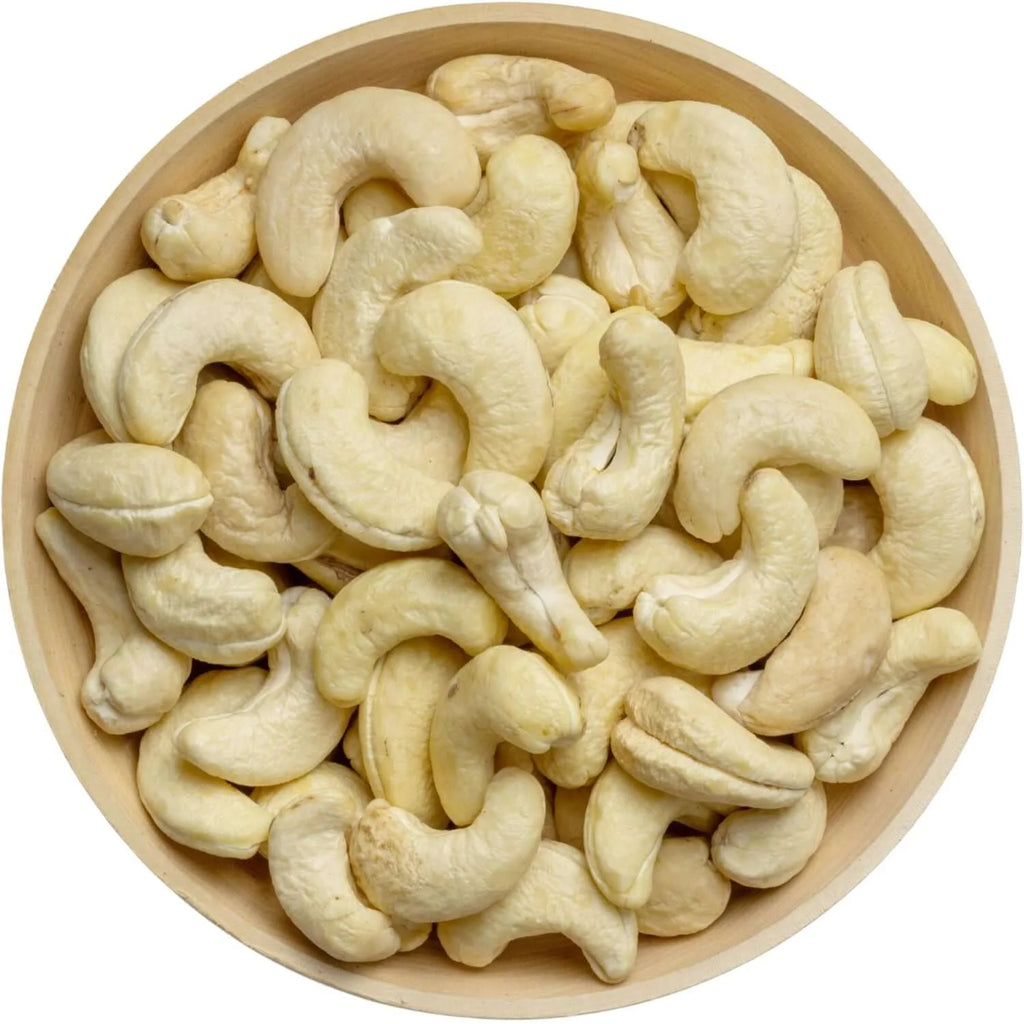 Wooden bowl filled with raw cashew nuts