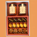 Gift set with jars labeled 'Ira' and assorted pastries on Diwali Ramadan& Christmas gift box