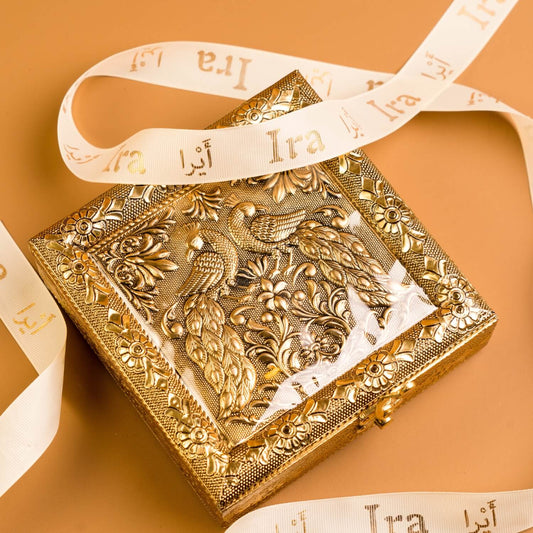 Decorative gold box with intricate designs and a ribbon on Diwali Ramadan& Christmas gift box