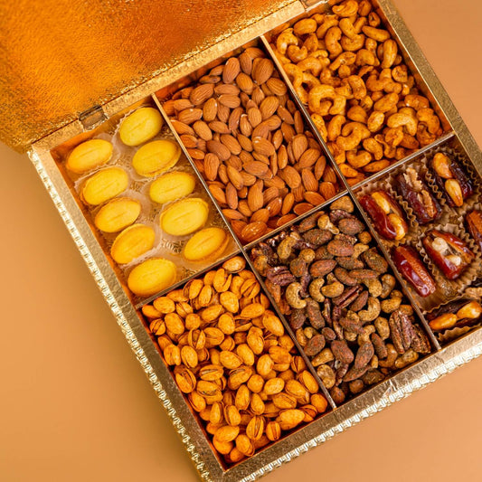 Assorted dried fruits and nuts in a decorative box on a beige background Diwali Ramadan& Christmas gift box