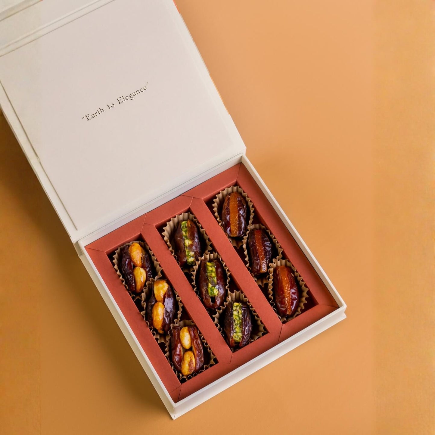 Box of assorted dried fruits on a beige background with 'Earth to Elegance' Diwali Ramadan& Christmas gift box