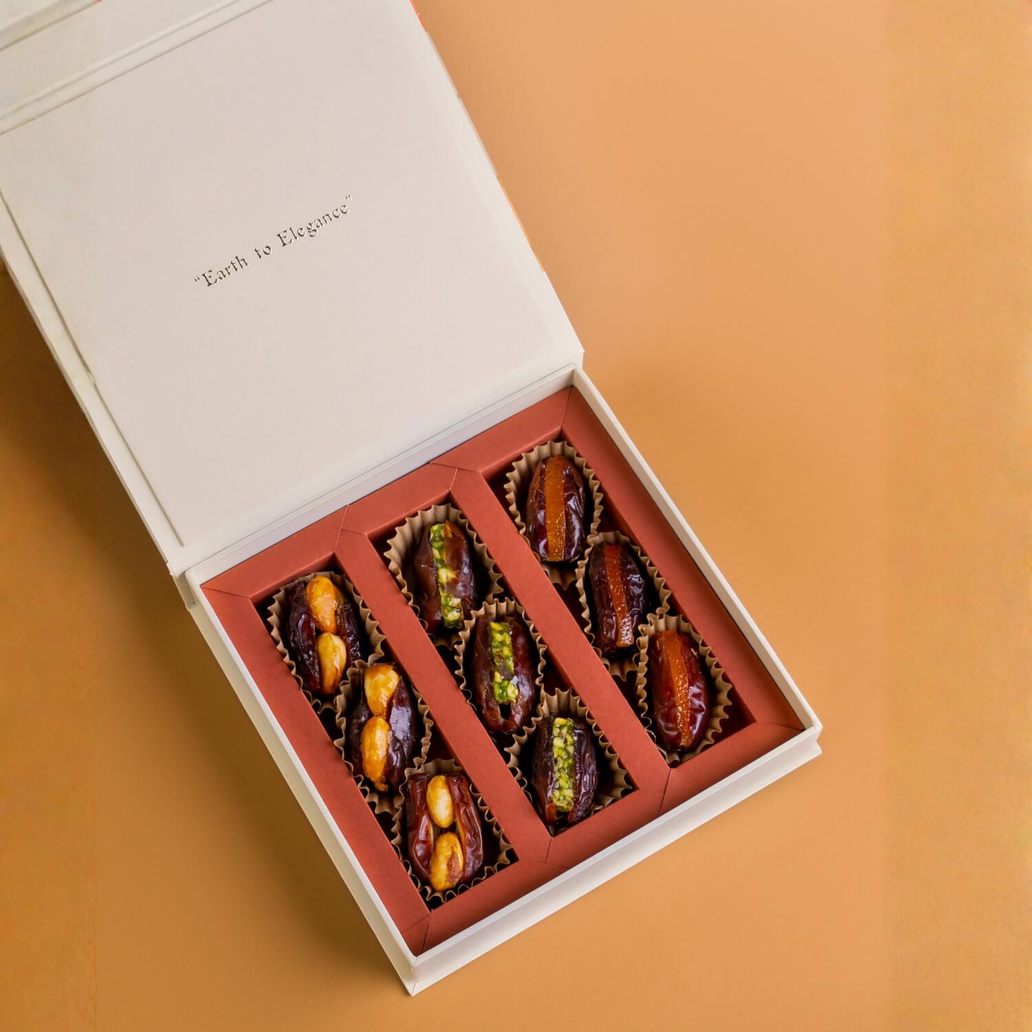 Box of assorted dried fruits on a beige background with 'Earth to Elegance' Diwali Ramadan& Christmas gift box