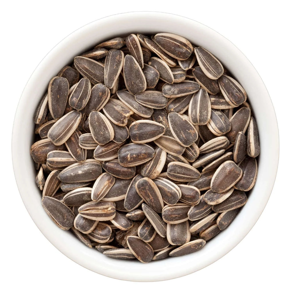 White bowl filled with shelled sunflower seeds