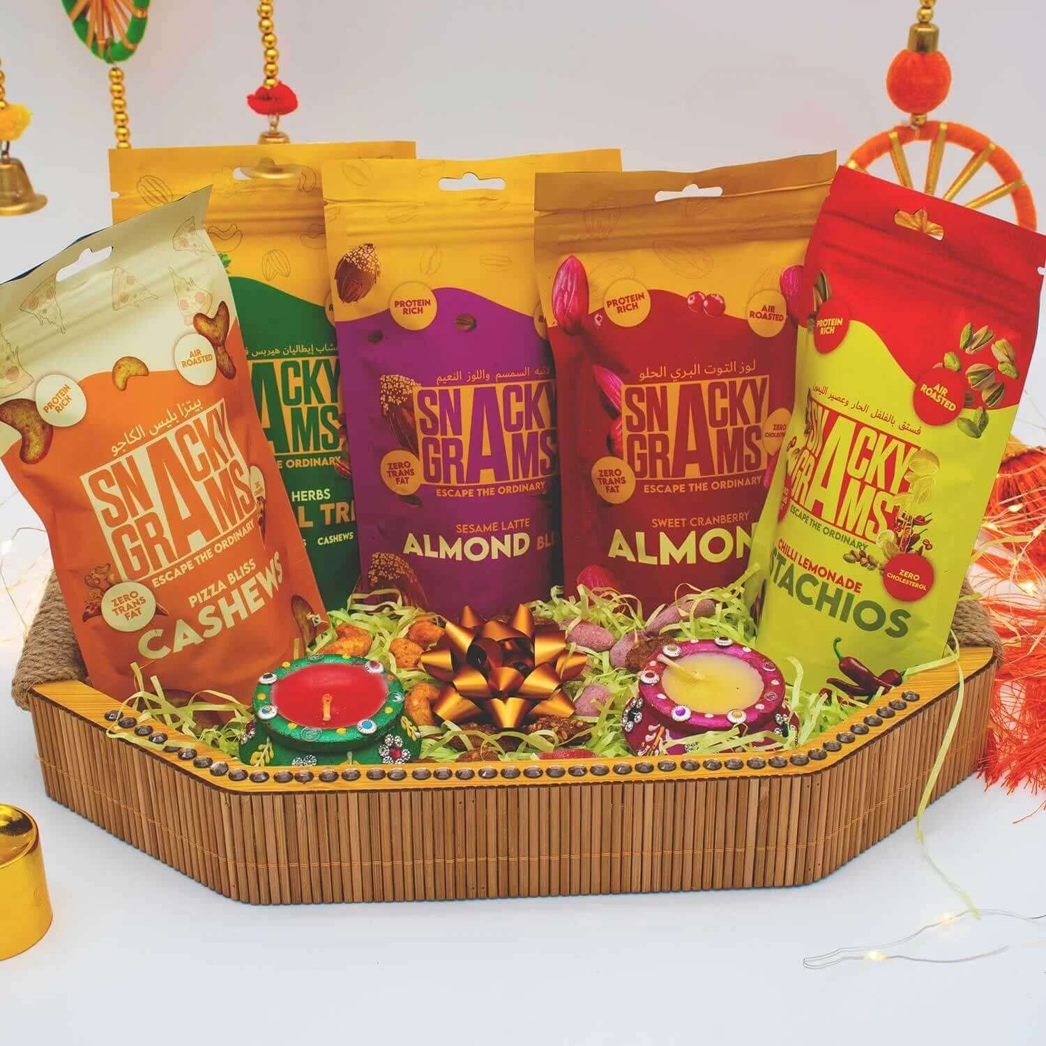 Assorted snack packages in colorful packaging on a decorative tray.