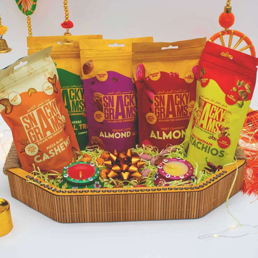 Assorted snack packages in colorful packaging on a decorative tray.